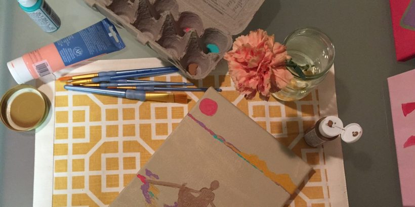 Overhead view of art supplies on a desk.