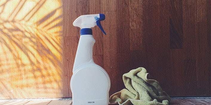 Spray bottle with cleaning cloth sitting next to it.